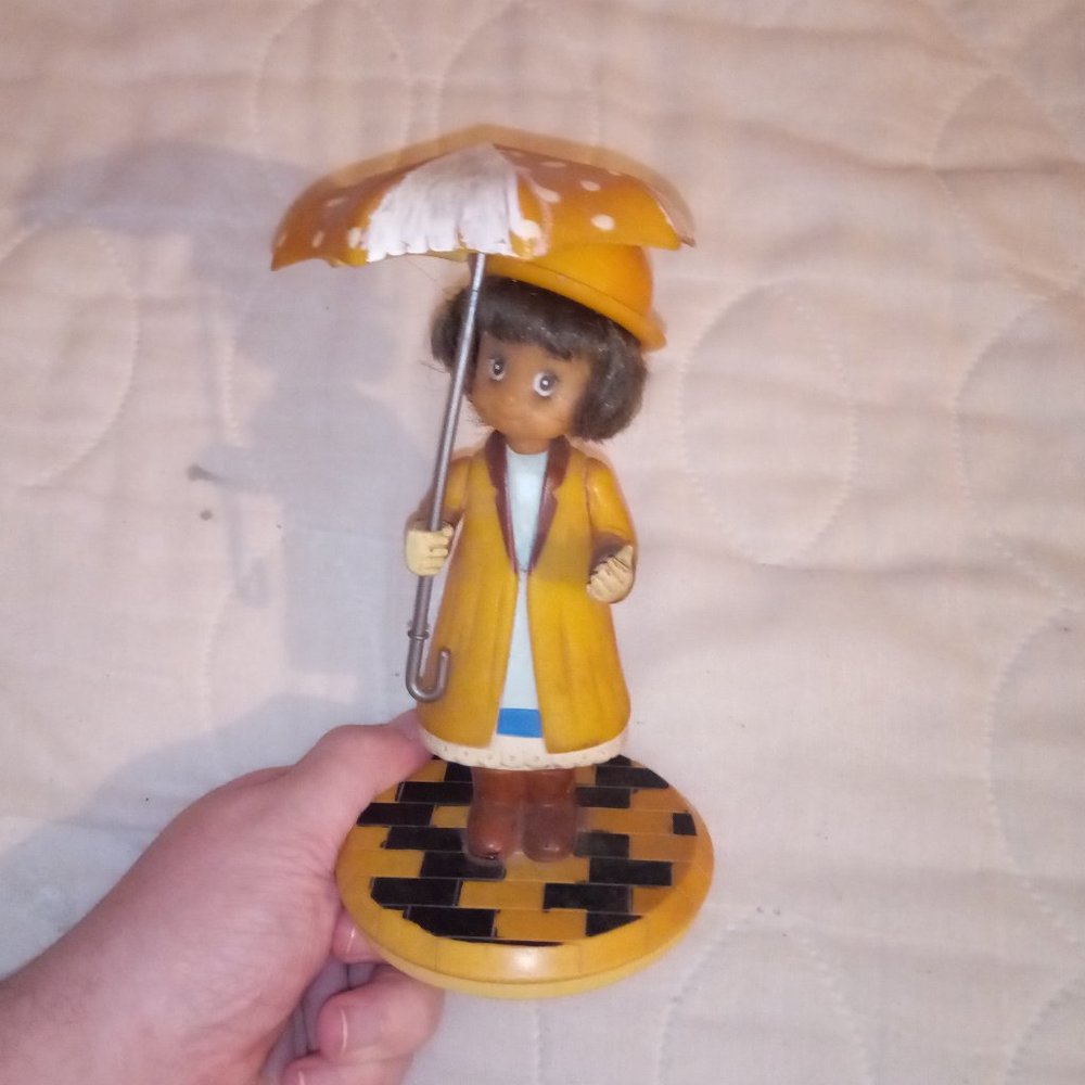 Antique Girl in Raincoat Holding a Umbrella Decoration